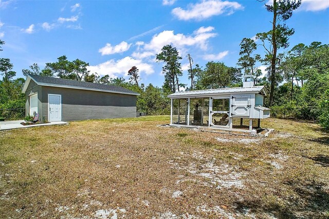 31857 Dahlia Ct, Eustis, FL 32736 - view of grassy yard featuring an outbuilding, exterior structure, and a garage