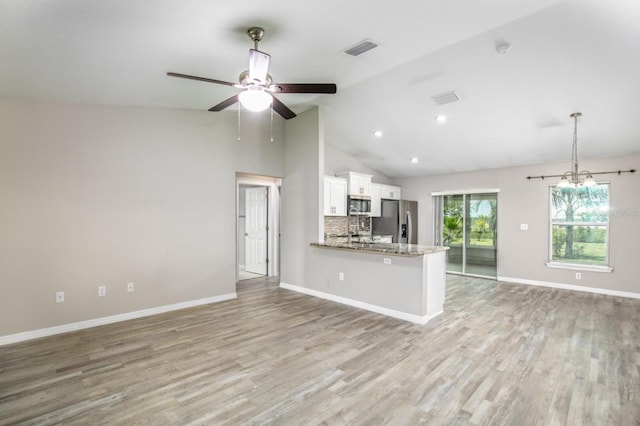unfurnished living room featuring visible vents, a ceiling fan, light wood-style floors, and baseboards