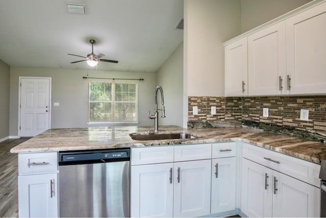 kitchen featuring a sink, dishwasher, a ceiling fan, decorative backsplash, and visible vents