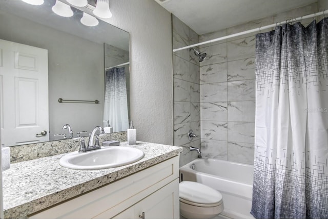 bathroom with toilet, a textured wall, shower / bath combo, and vanity