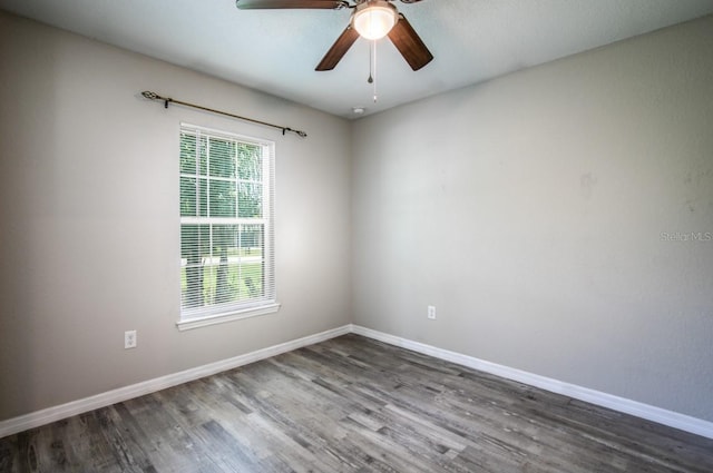 unfurnished room featuring baseboards, ceiling fan, and wood finished floors