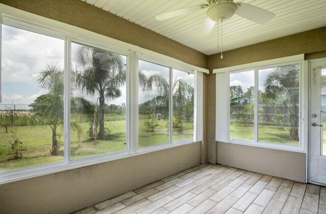 unfurnished sunroom with plenty of natural light and wood finished floors