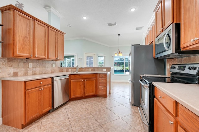8709 Augusta Ct, Clermont, FL 34711 - kitchen with crown molding, a sink, stainless steel appliances, a peninsula, and decorative backsplash