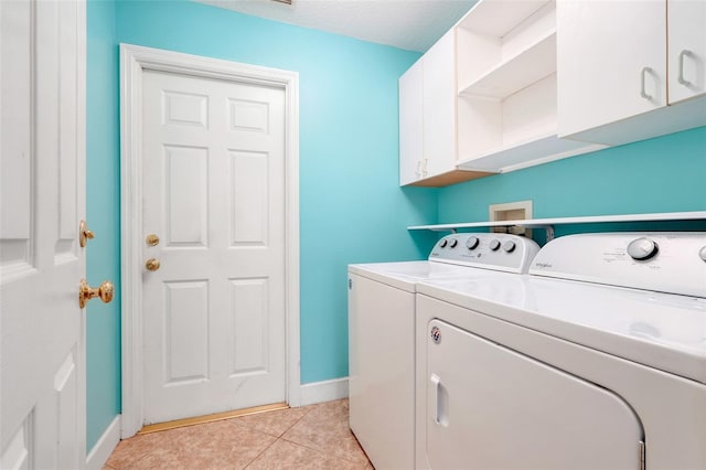8709 Augusta Ct, Clermont, FL 34711 - laundry room with baseboards, light tile patterned flooring, cabinet space, and washer and clothes dryer