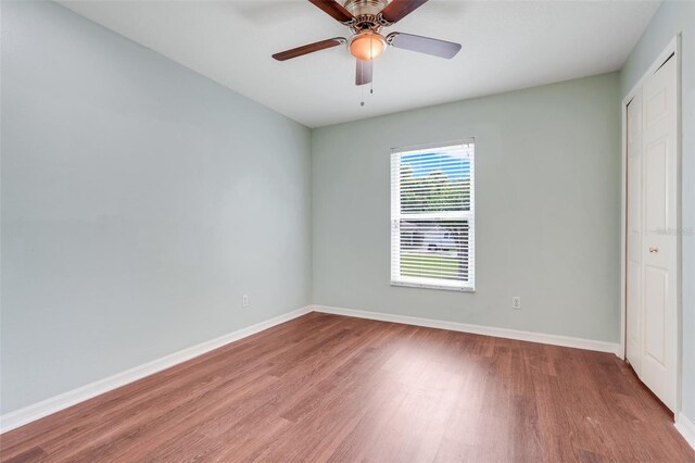 8709 Augusta Ct, Clermont, FL 34711 - unfurnished bedroom with baseboards, ceiling fan, a closet, and wood finished floors