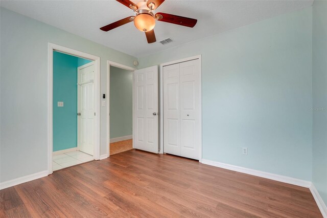 8709 Augusta Ct, Clermont, FL 34711 - unfurnished bedroom featuring baseboards, a closet, wood finished floors, and visible vents