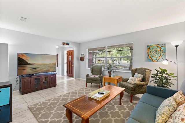 living room featuring visible vents, baseboards, and light tile patterned floors