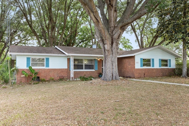 single story home with brick siding and a front lawn