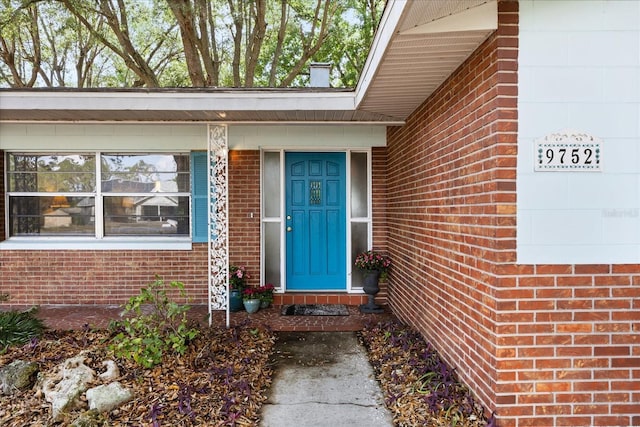 entrance to property with brick siding