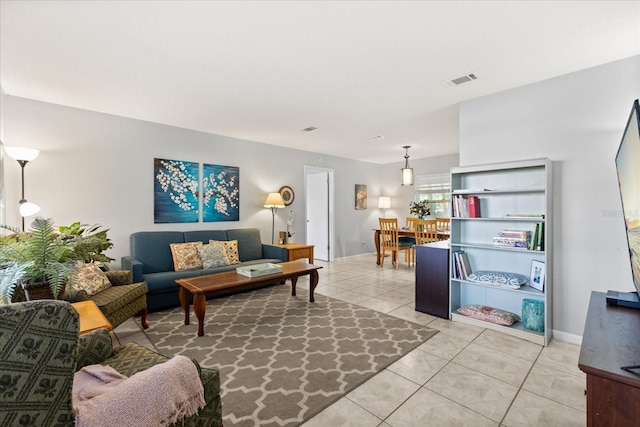 living room with light tile patterned flooring and visible vents