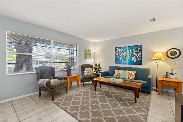 living room featuring visible vents, baseboards, and light tile patterned flooring