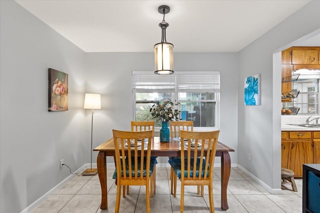 dining space featuring light tile patterned floors and baseboards