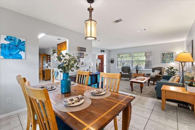 dining space with baseboards, visible vents, and light tile patterned floors