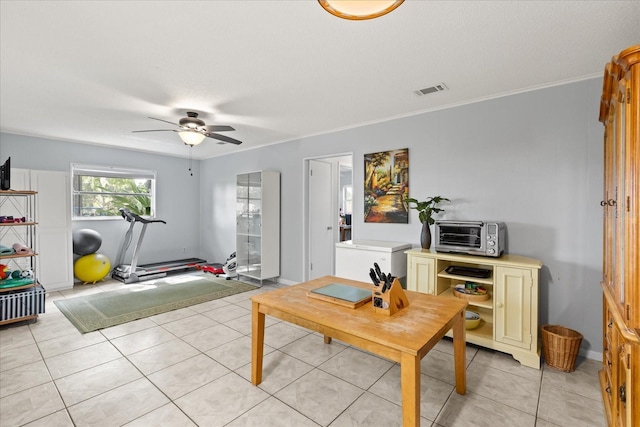 living area featuring visible vents, ornamental molding, a toaster, a ceiling fan, and light tile patterned floors