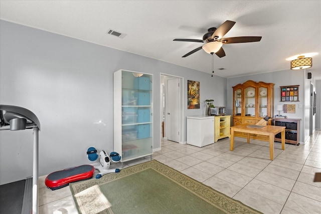 workout area with ceiling fan, visible vents, and light tile patterned floors