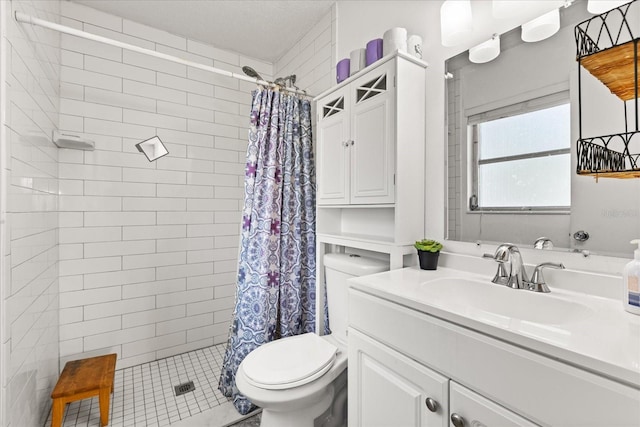 full bath featuring vanity, toilet, and tiled shower