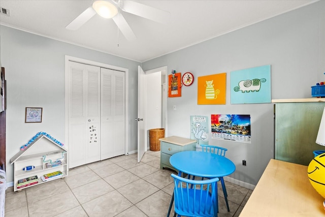 game room featuring ceiling fan, visible vents, crown molding, tile patterned floors, and baseboards