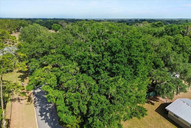birds eye view of property with a wooded view
