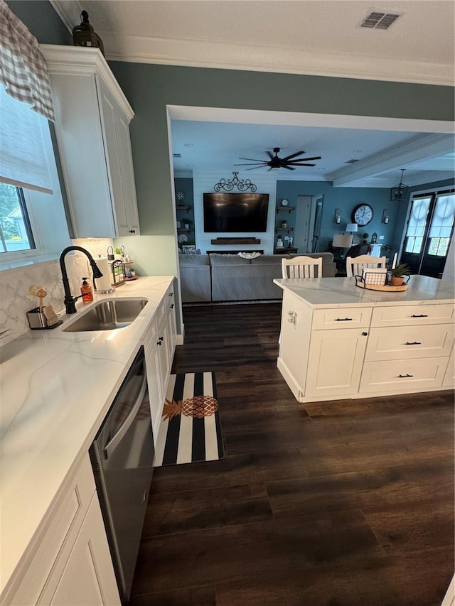 kitchen with stainless steel dishwasher, a sink, dark wood-type flooring, open floor plan, and ceiling fan