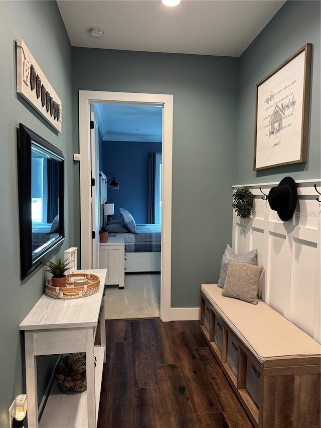 mudroom with dark wood-style floors and baseboards