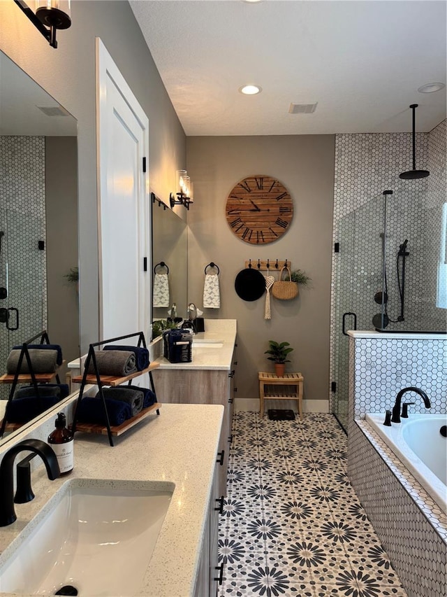 full bath with a shower stall, double vanity, a bath, baseboards, and recessed lighting