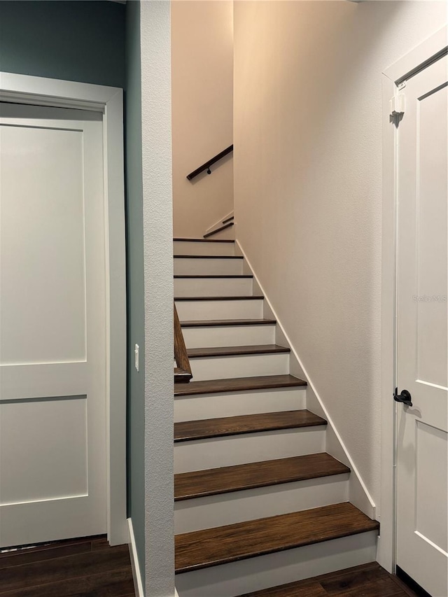 stairs featuring wood finished floors