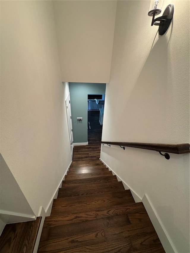stairs with wood finished floors and baseboards
