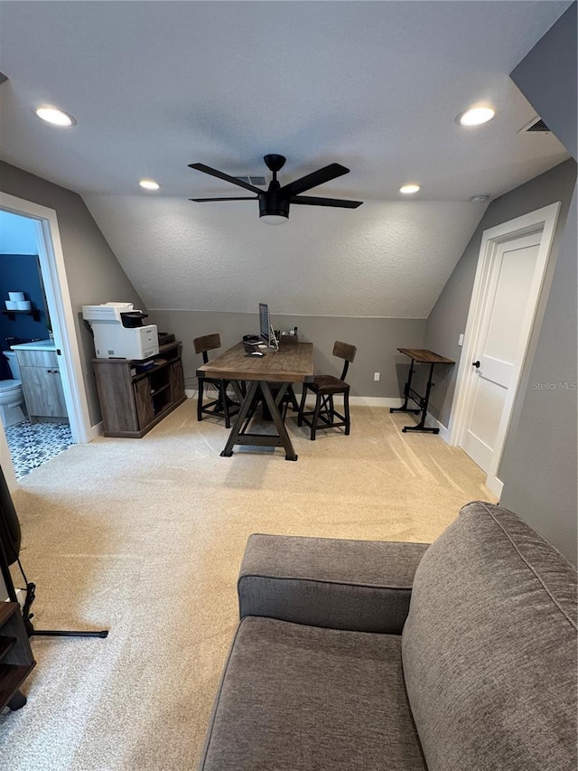 carpeted living area featuring a ceiling fan, lofted ceiling, a desk, baseboards, and recessed lighting