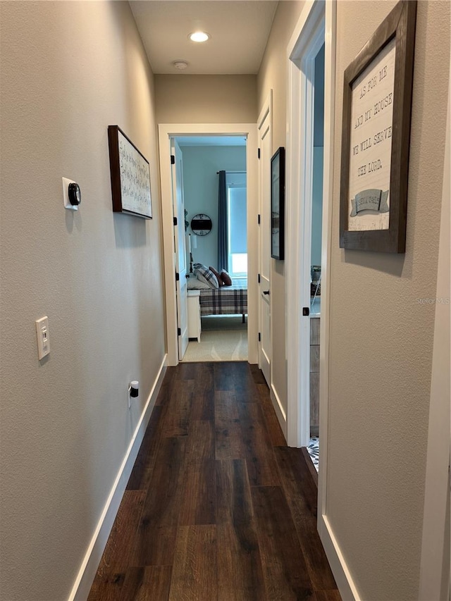 corridor with baseboards, dark wood-style flooring, and recessed lighting