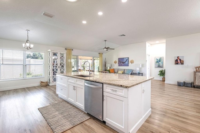 kitchen with a sink, light wood-style flooring, ceiling fan with notable chandelier, and dishwasher
