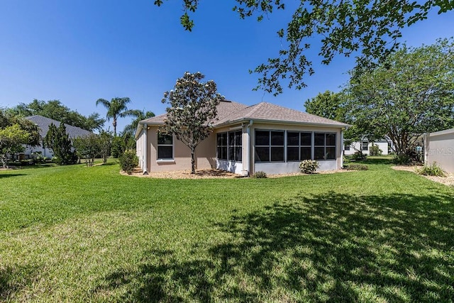 back of house featuring a lawn