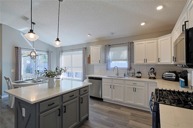 1451 Rosedale Way, The Villages, FL 32162 - kitchen with a sink, dishwasher, a textured ceiling, gray cabinets, and black gas range