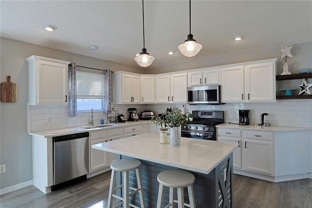 1451 Rosedale Way, The Villages, FL 32162 - kitchen featuring white cabinets, open shelves, appliances with stainless steel finishes, a sink, and dark wood finished floors