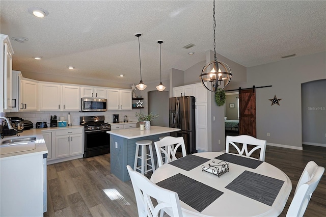 1451 Rosedale Way, The Villages, FL 32162 - dining space with a textured ceiling, recessed lighting, a barn door, and wood finished floors