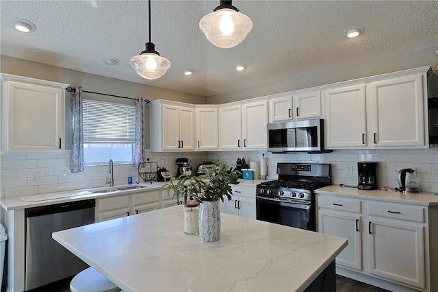1451 Rosedale Way, The Villages, FL 32162 - kitchen with a textured ceiling, white cabinets, a sink, backsplash, and stainless steel appliances