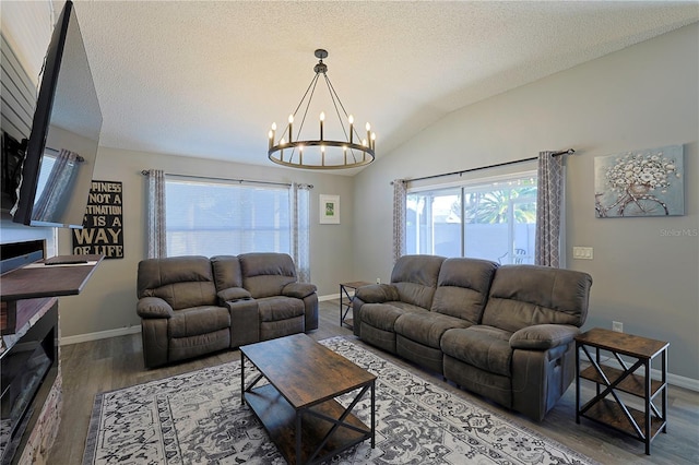 1451 Rosedale Way, The Villages, FL 32162 - living area with an inviting chandelier, a textured ceiling, baseboards, wood finished floors, and vaulted ceiling
