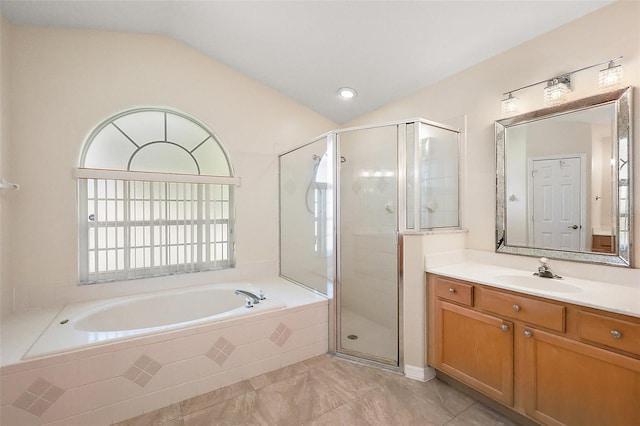 bathroom featuring vaulted ceiling, a garden tub, and a shower stall