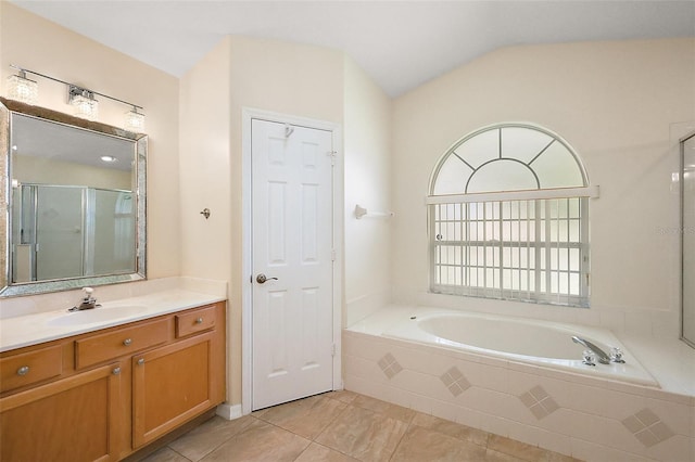 full bath with lofted ceiling, vanity, tile patterned floors, a stall shower, and a bath