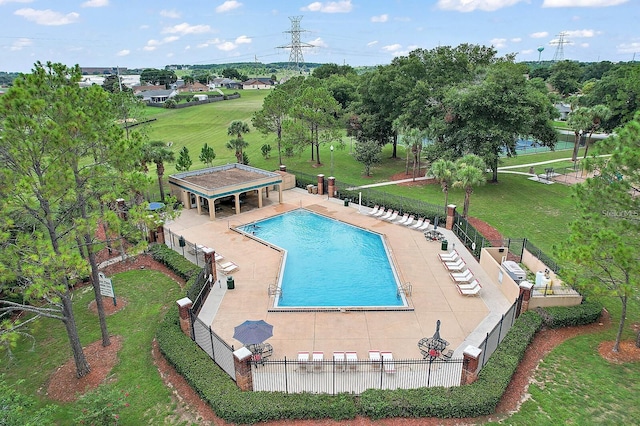 pool with a gazebo, fence, a patio area, and a lawn