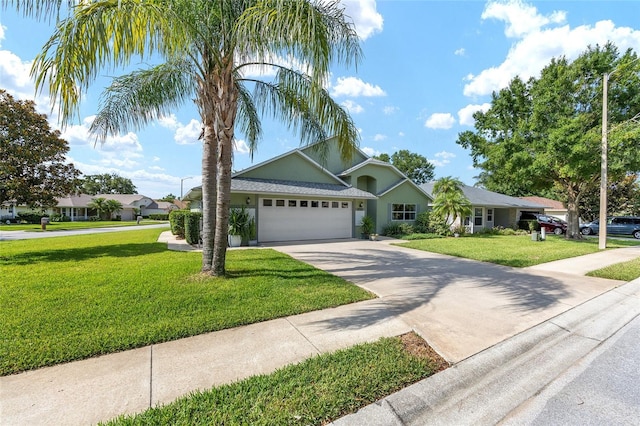2750 Coral Reef Way, Tavares, FL 32778 - view of front of property featuring a garage, concrete driveway, a front yard, and stucco siding