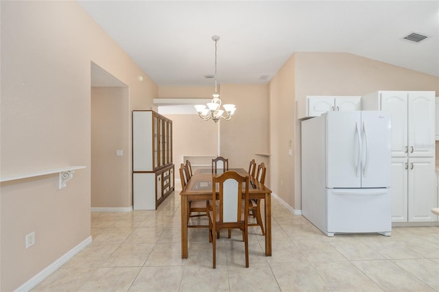 2750 Coral Reef Way, Tavares, FL 32778 - dining room with a chandelier, vaulted ceiling, and light tile patterned floors