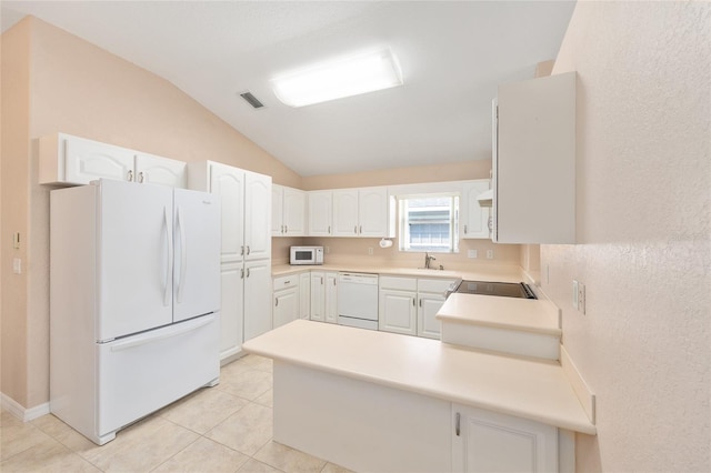 2750 Coral Reef Way, Tavares, FL 32778 - kitchen featuring white appliances, a peninsula, lofted ceiling, white cabinets, and light tile patterned floors