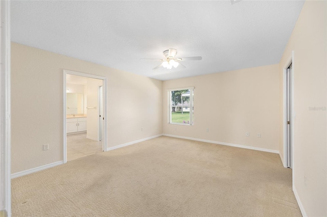 2750 Coral Reef Way, Tavares, FL 32778 - unfurnished bedroom featuring light colored carpet, ensuite bathroom, and ceiling fan