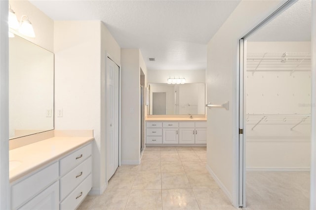 2750 Coral Reef Way, Tavares, FL 32778 - bathroom featuring vanity, tile patterned floors, and a spacious closet