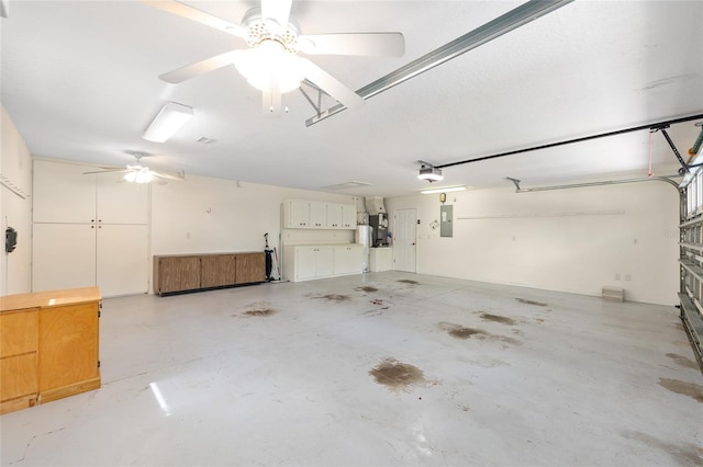 2750 Coral Reef Way, Tavares, FL 32778 - garage featuring a garage door opener, electric panel, and ceiling fan