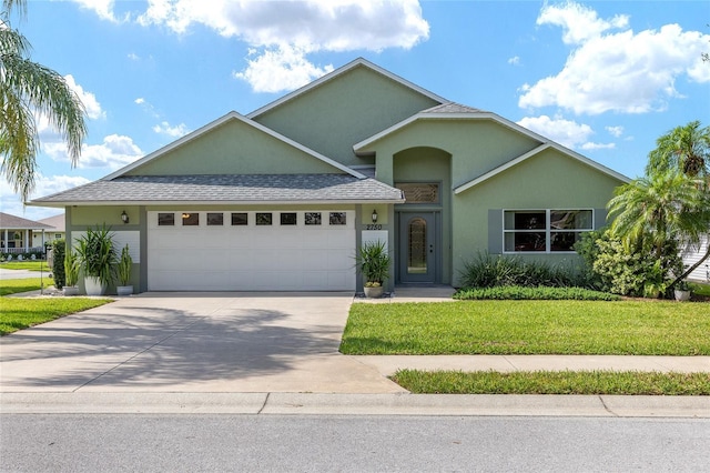 2750 Coral Reef Way, Tavares, FL 32778 - view of front of house with an attached garage, stucco siding, a front lawn, driveway, and a shingled roof