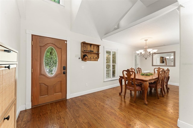 entrance foyer with baseboards, light wood finished floors, and a notable chandelier