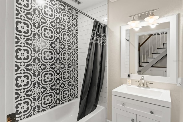 full bath featuring visible vents, shower / bath combo, and vanity