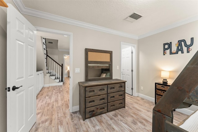 bedroom with visible vents, ornamental molding, light wood-style flooring, and baseboards