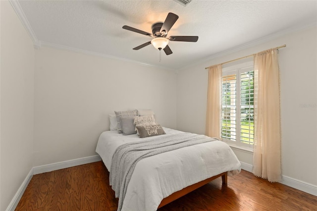 bedroom featuring crown molding, a ceiling fan, baseboards, and wood finished floors